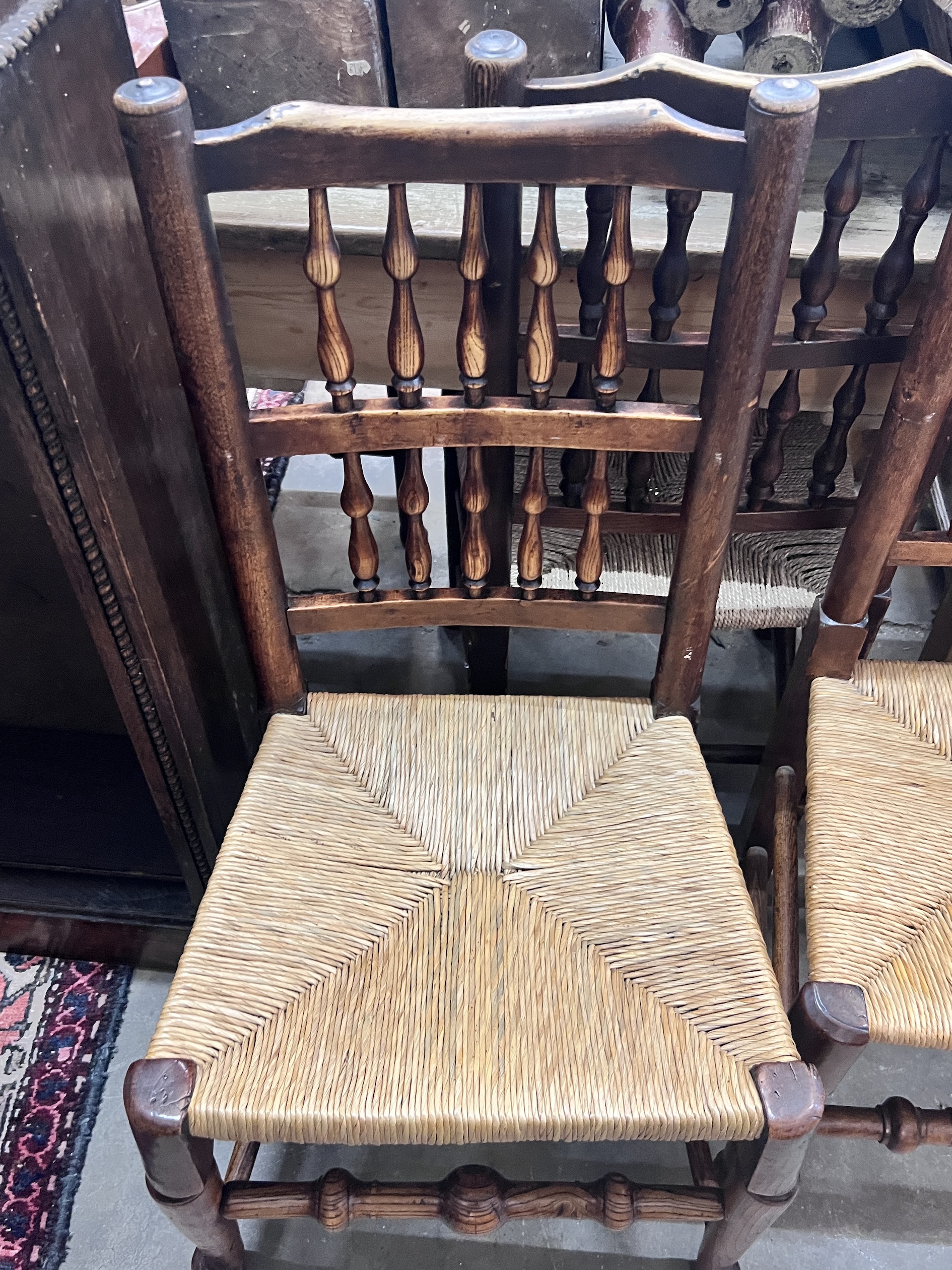 A harlequin set of six 19th century Lancashire ash and beach rush seat spindle back dining chairs